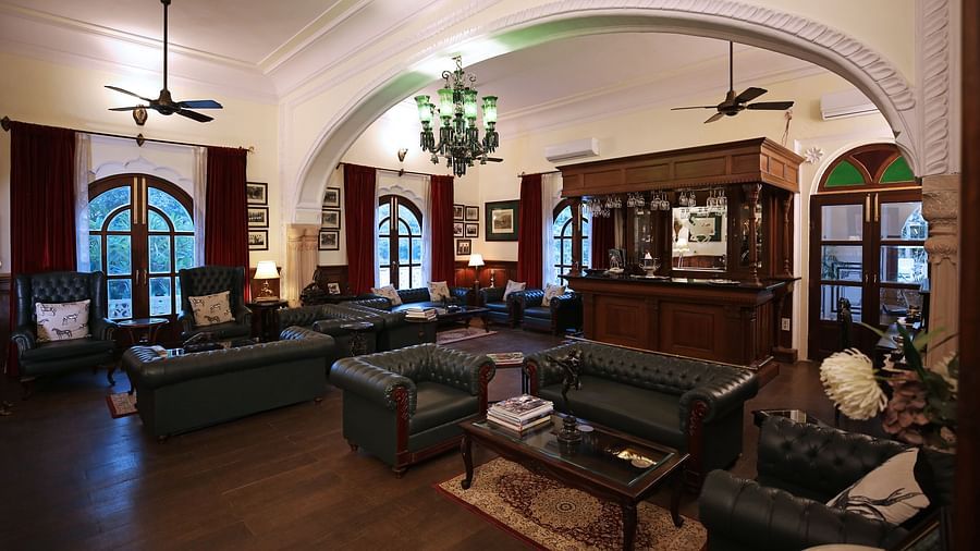 A spacious hotel lounge area with comfortable sofas and traditional wooden furniture - Khas Bagh, Jaipur.