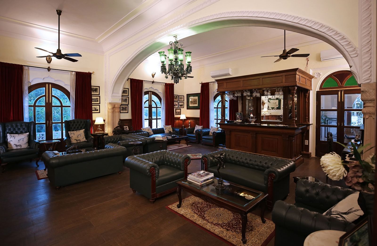 A spacious hotel lounge area with comfortable sofas and traditional wooden furniture - Khas Bagh, Jaipur.