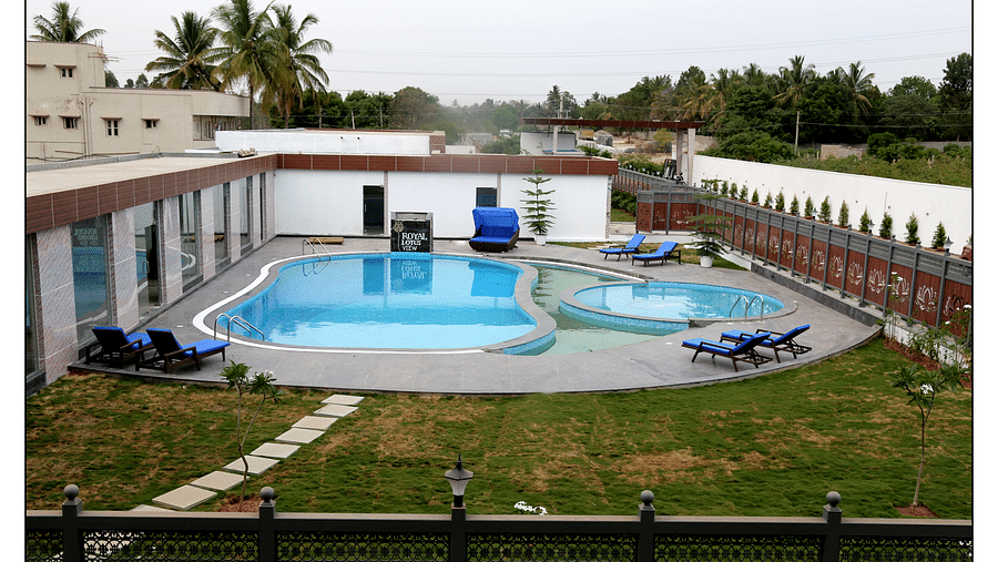 a different angle of the swimming pool surrounded by a green lawn - Royal Lotus View Resotel