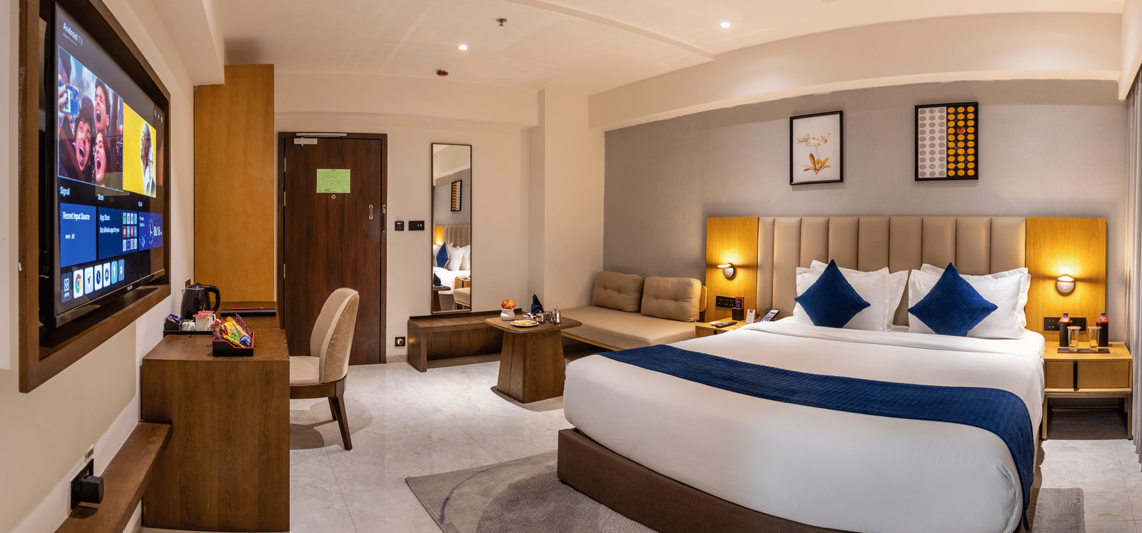 Stylish accommodation with contemporary decor and entertainment setup at Lords Studio Inn, Jamnagar.