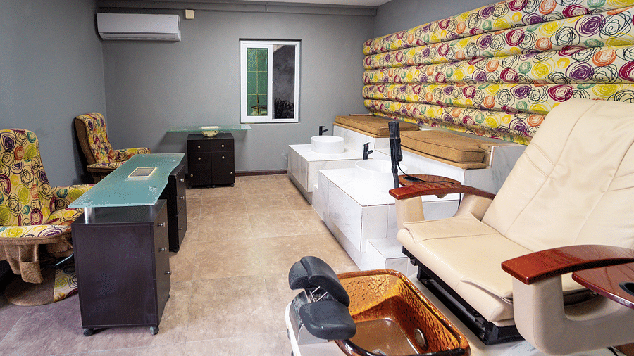 An image of a spa room in Montego Bay with massage chairs, hair washing chairs and wall-mounted AC - Hotel 39, Jamaica (Montego Bay)