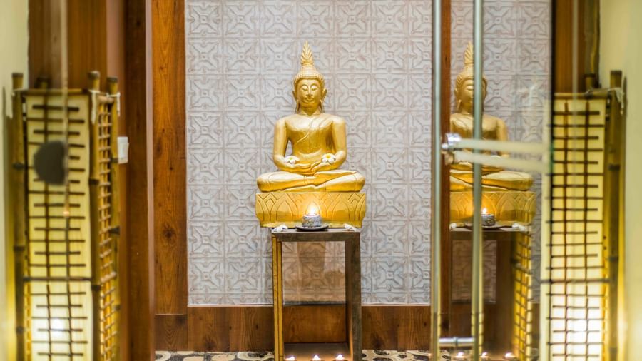 A decorative golden pagoda and candles, possibly in a wellness area at The Citi Residenci Hotel, Durgapur.