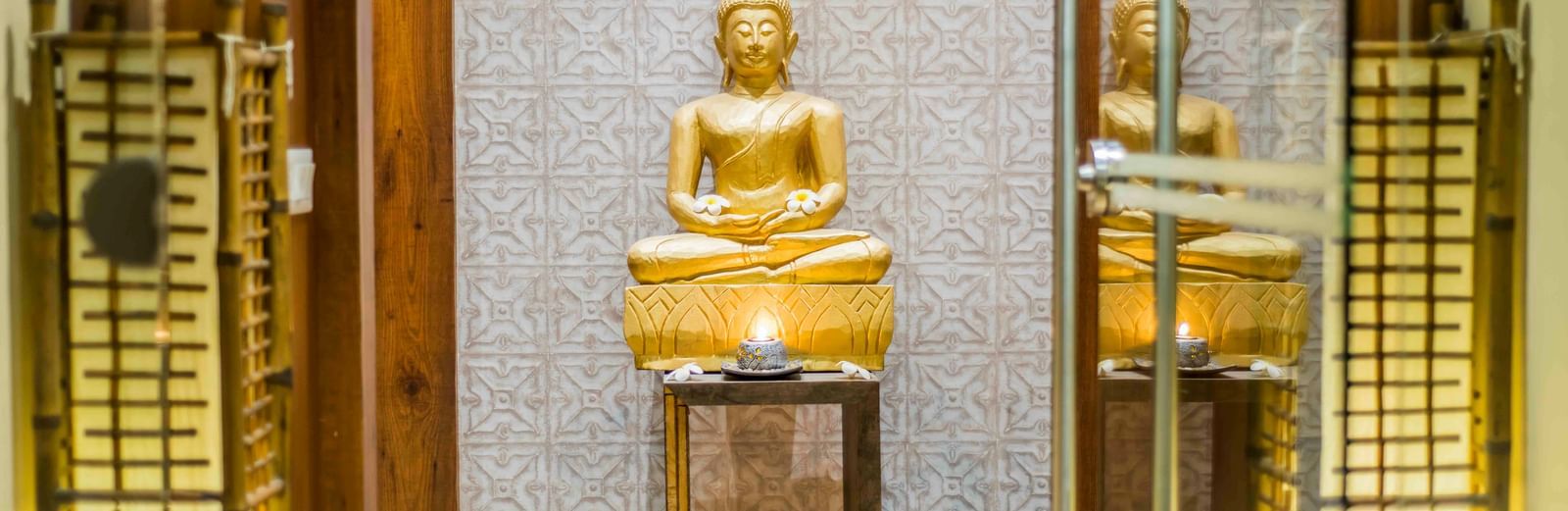 A decorative golden pagoda and candles, possibly in a wellness area at The Citi Residenci Hotel, Durgapur.