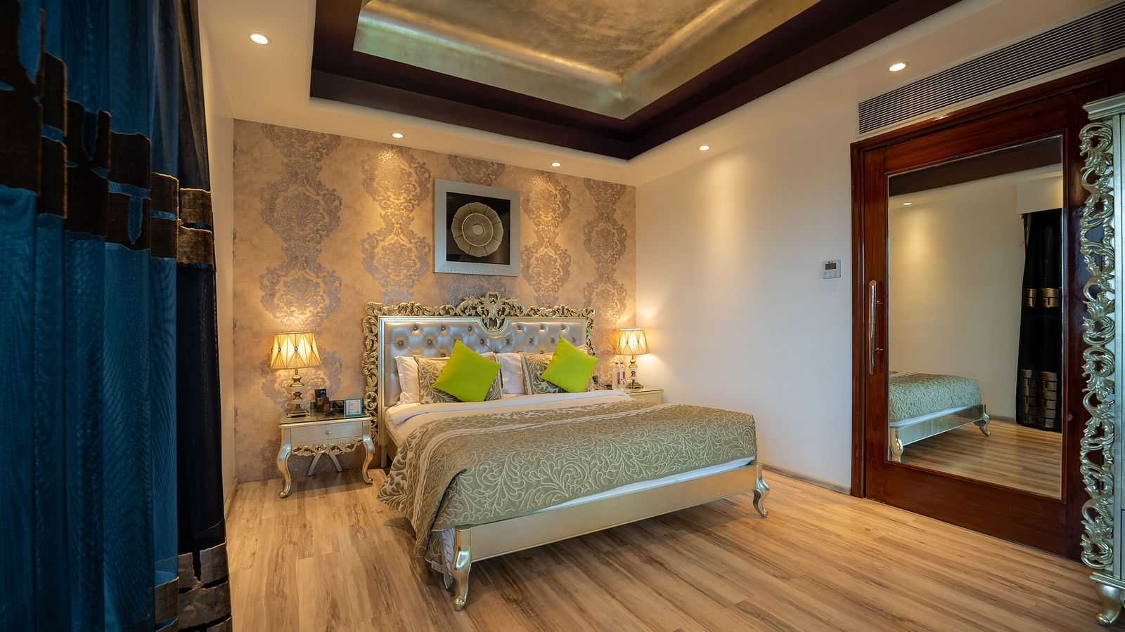 At Crescent Spa & Resort, Indore, the spacious bed features a photo frame above the headboard and is accompanied by two bedside tables illuminated with warm lighting