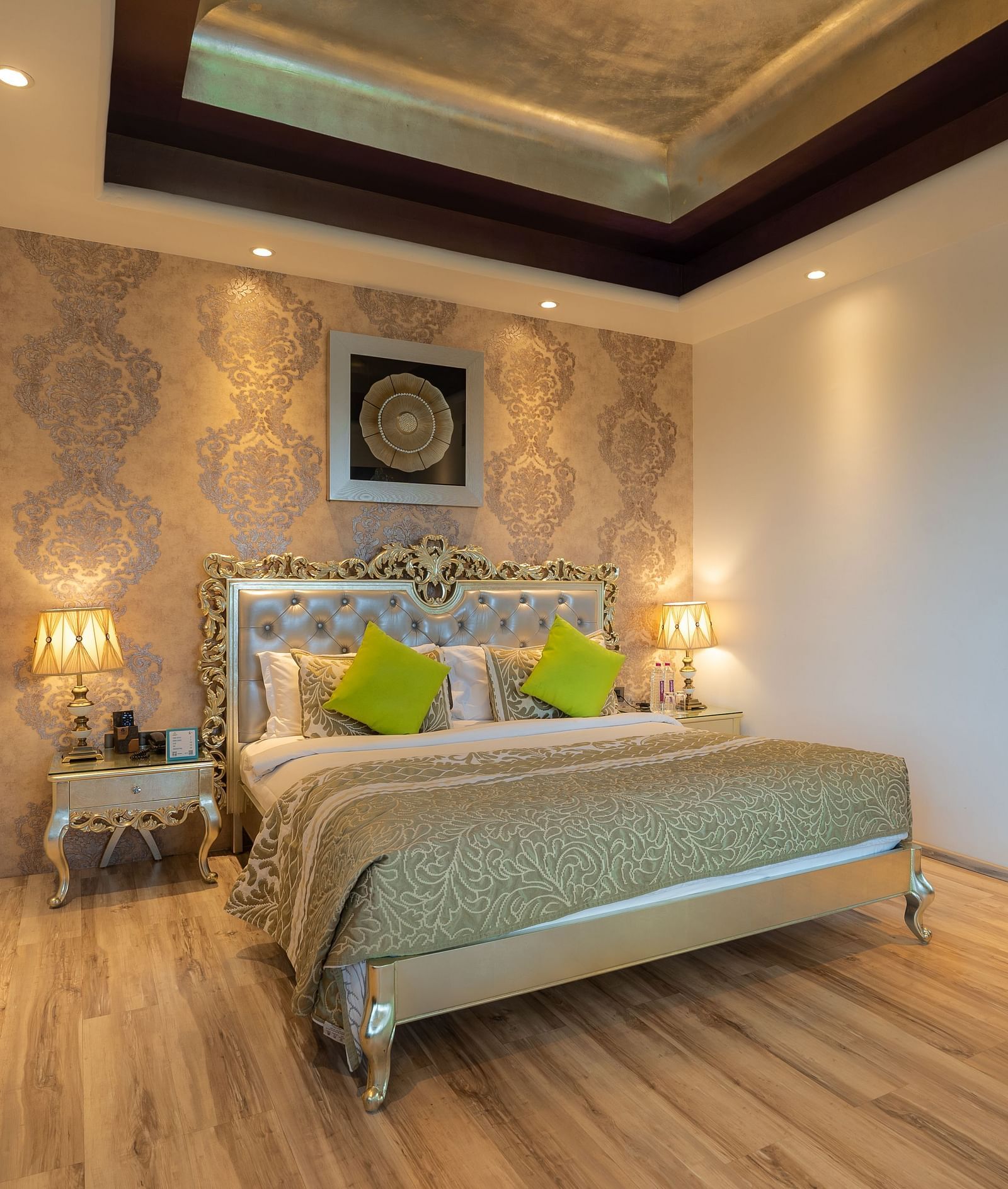 At Crescent Spa & Resort, Indore, the spacious bed features a photo frame above the headboard and is accompanied by two bedside tables illuminated with warm lighting