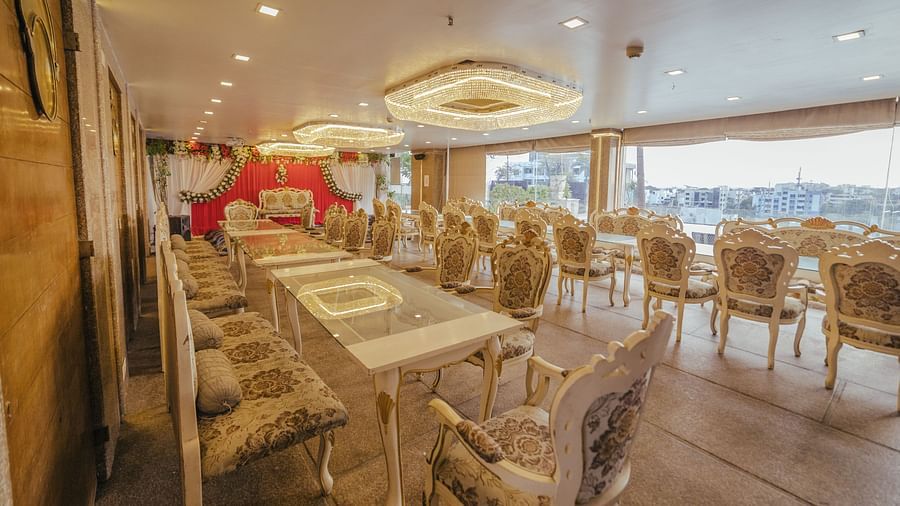 Poolview set up for a meal with long tables, chairs, and decorative elements like a floral arch.