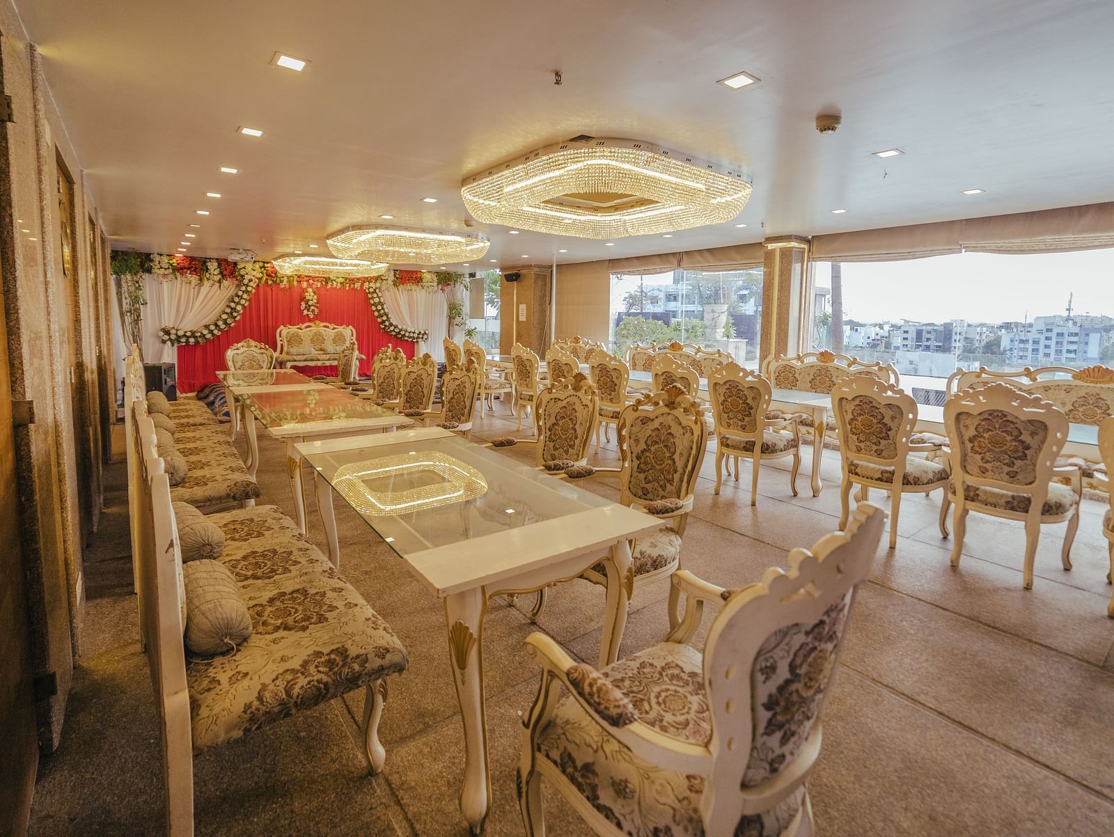 Poolview set up for a meal with long tables, chairs, and decorative elements like a floral arch.