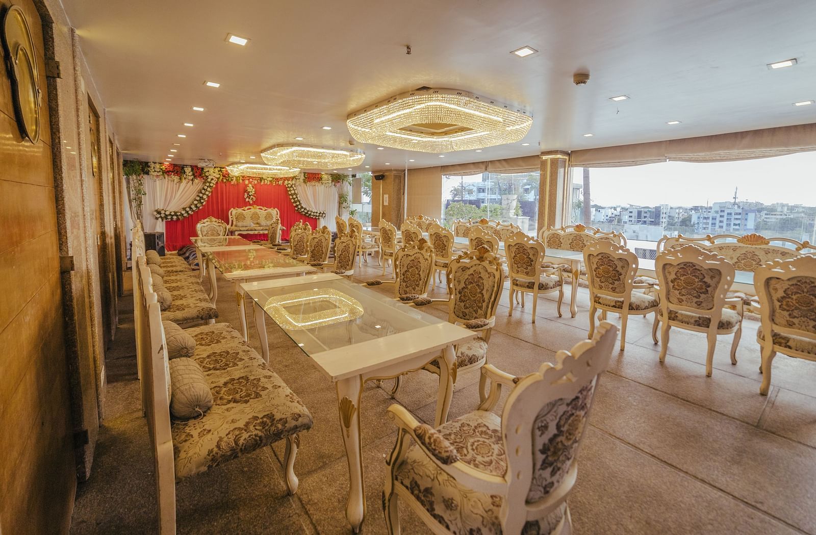 Poolview set up for a meal with long tables, chairs, and decorative elements like a floral arch.