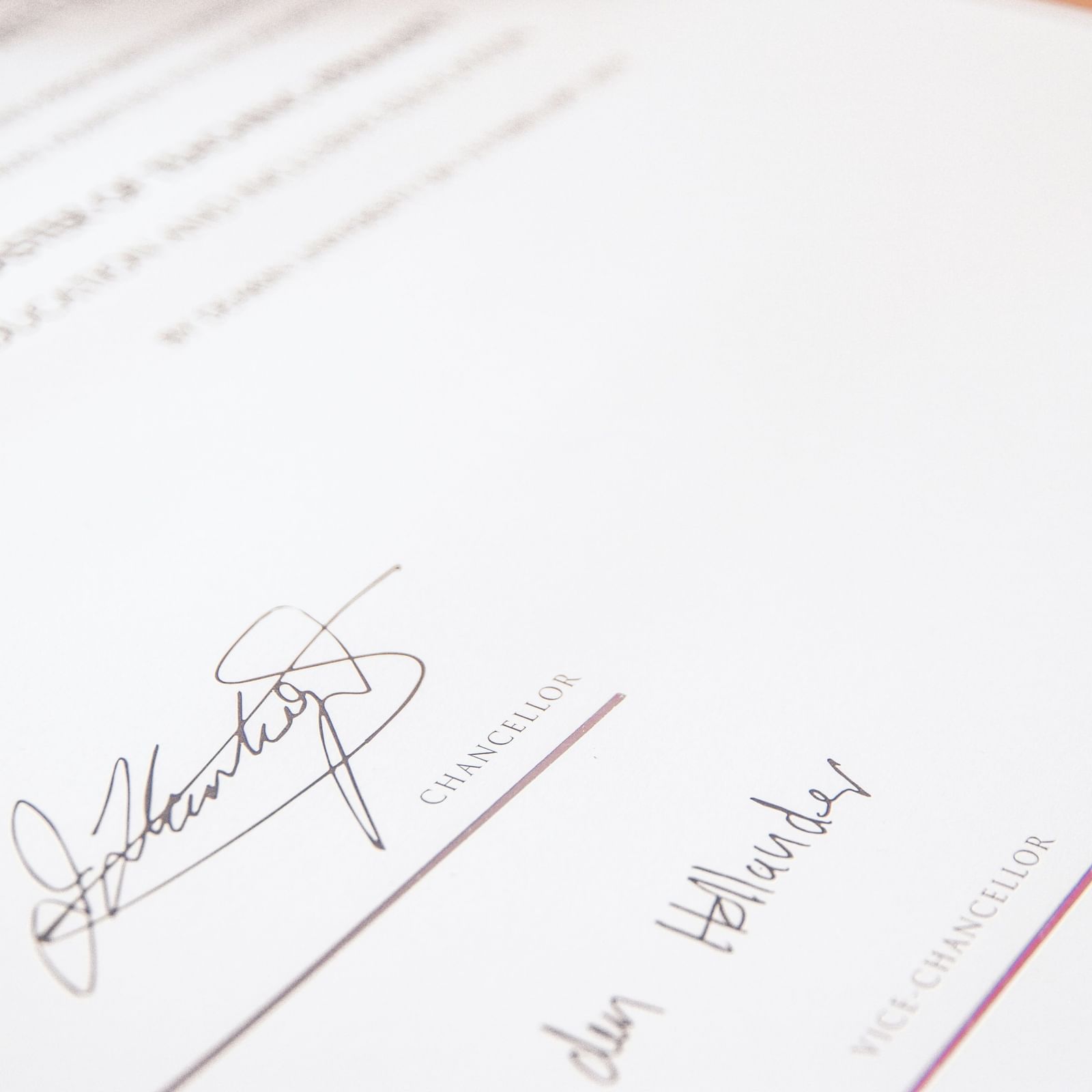 A document on a table with signatures and a red circular stamp.