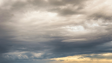 Panoramic cloudy sky view over the lush hills and surrounding valleys.