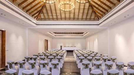 Image of Arabica banquet hall with a seating arrangement and a large chandelier. | Great Trails Wayanad by  GRT hotels | Best Conference hall in Wayanad