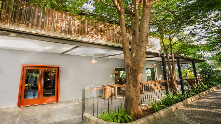 facade image of the mekong restaurant on a bright day with grey walls in the exterior at Darza Resorts  offering an exceptional resort dining in Coimbatore experience.