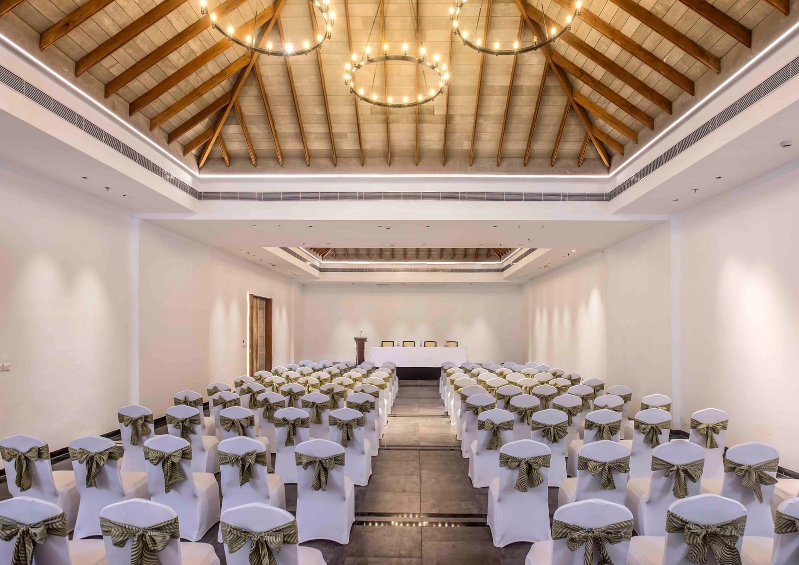 Image of Arabica banquet hall with a seating arrangement and a large chandelier. | Great Trails Wayanad by  GRT hotels | Best Conference hall in Wayanad