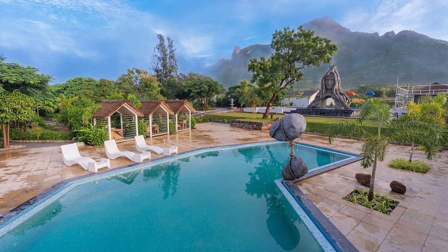 full view image of the swimming pool with three sun loungers at the poolside - Darza Resorts