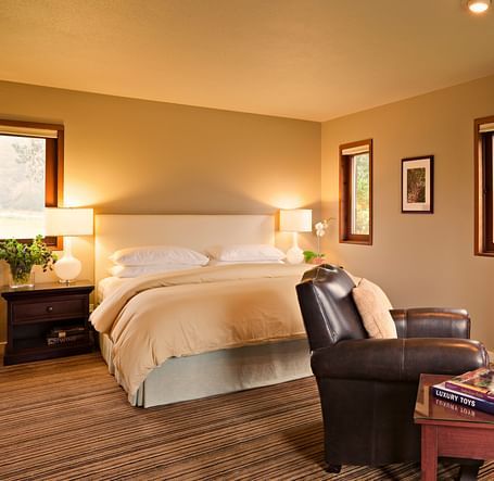 A hotel room with a fireplace, king bed, and rustic charm - Brewery Gulch Inn & Spa