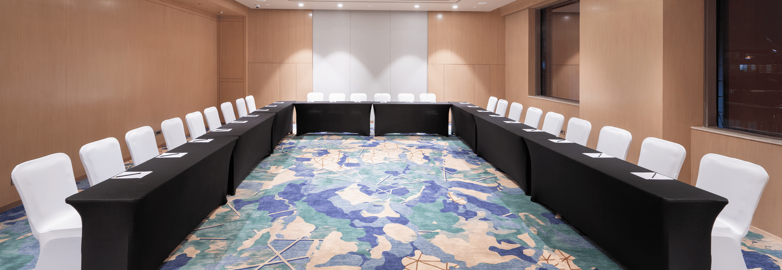 Elegant meeting space with U-shaped seating and warm lighting at Merlis Hotel, Coimbatore - Best banquet halls in Coimbatore