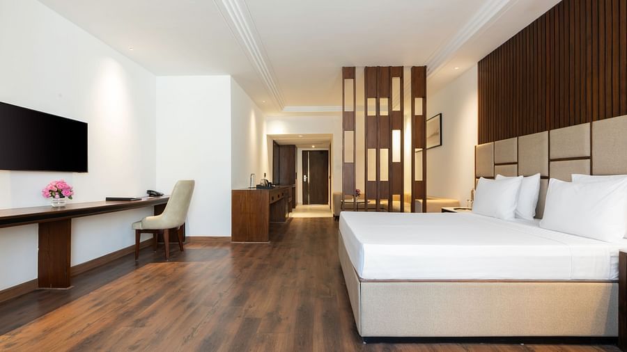 Modern hotel room with a minimalist design and natural light - Clarks Inn, Dehradun