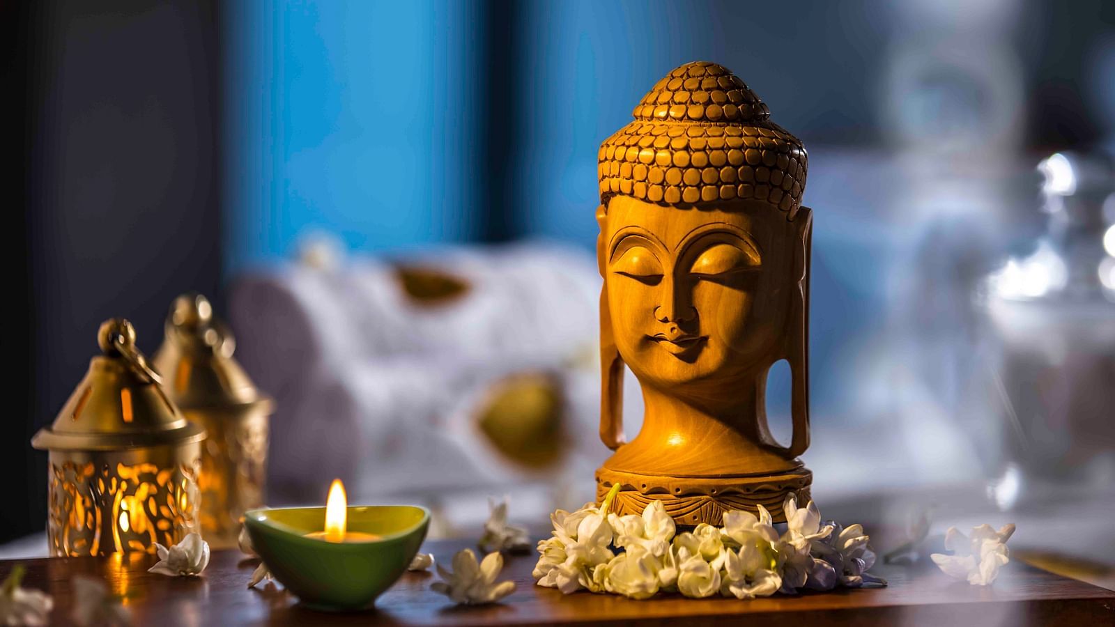 Image of a buddha statue with a lamp - Great Trails Wayanad by GRT hotels.