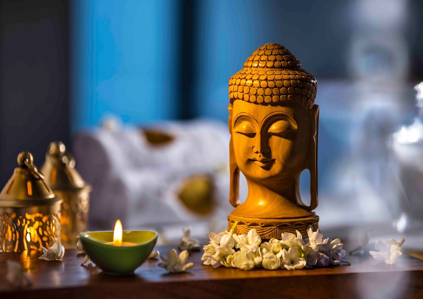 Image of a buddha statue with a lamp - Great Trails Wayanad by GRT hotels.