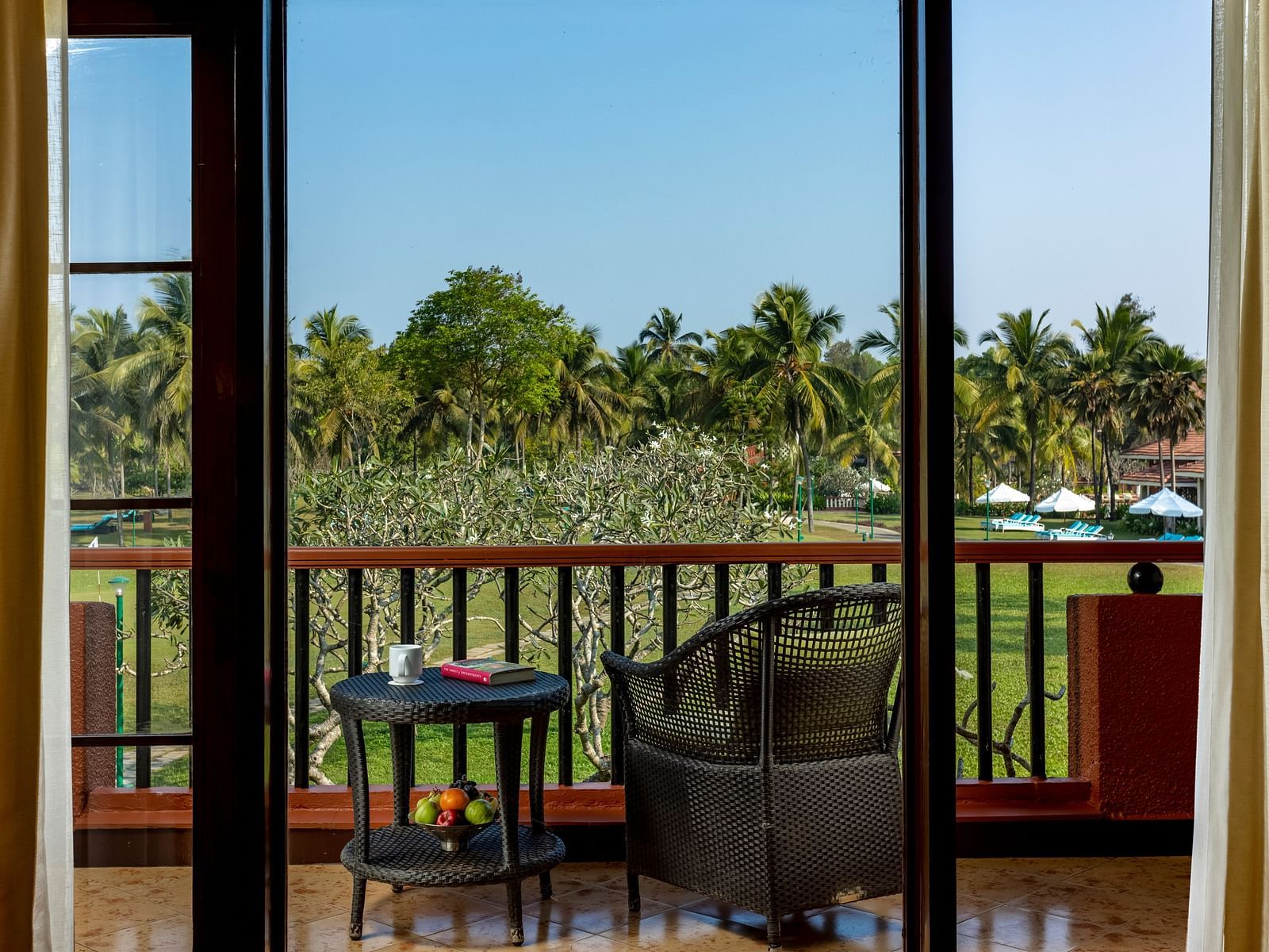 view of the balcony with chairs and a table on it inside Garden View Room - Caravela Beach Resort Goa 