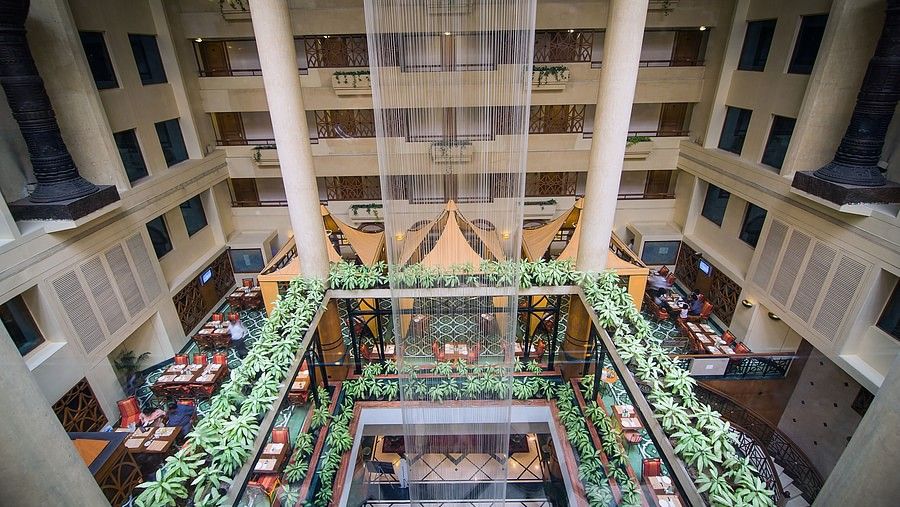 top view of the fountain in the lobby at the orchid hotel mumbai with dining area near it