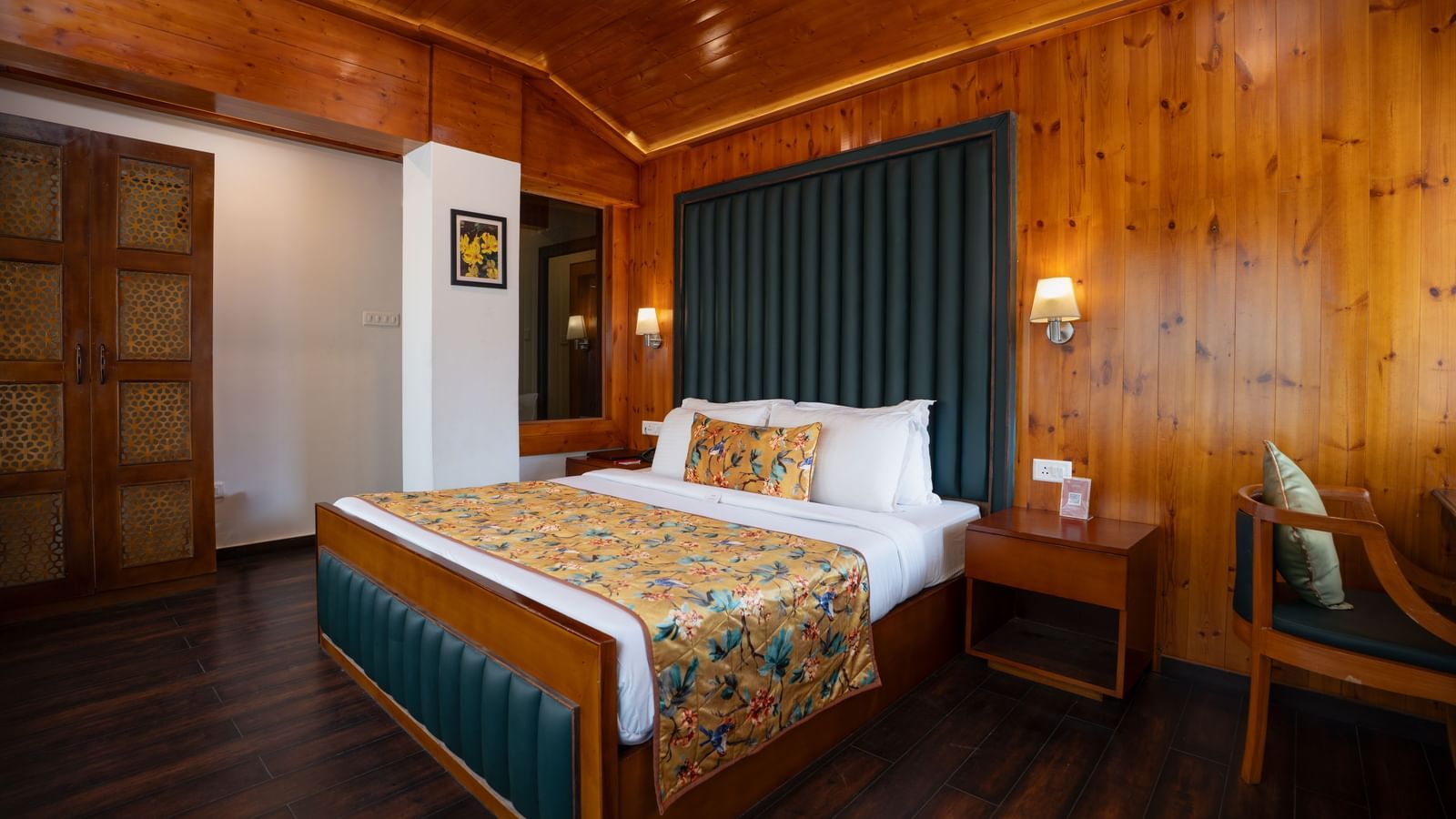 Suite at Summit North Star, Gangtok featuring a bed, a bedside table and a chair.