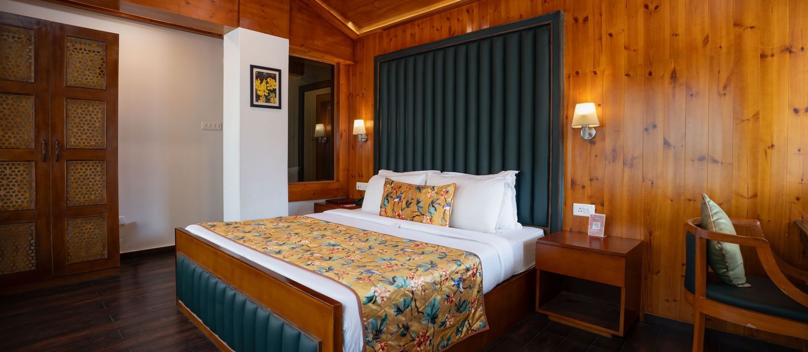 Suite at Summit North Star, Gangtok featuring a bed, a bedside table and a chair.