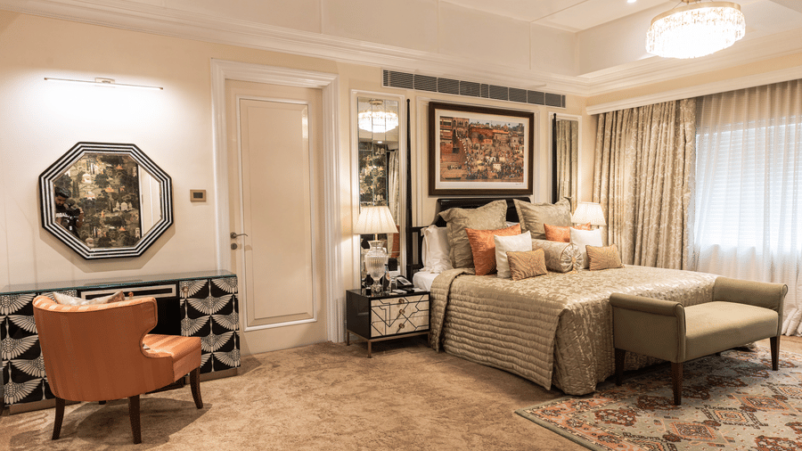 image of the bed and the bureau with a hexagonal mirror above it at our willingdon crescent suite - The Claridges New Delhi