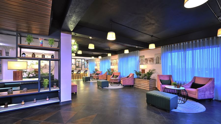 An image of our bar in Agra with comfortable couches and a bar counter - Rooftop in Agra - Golden Tulip, Agra