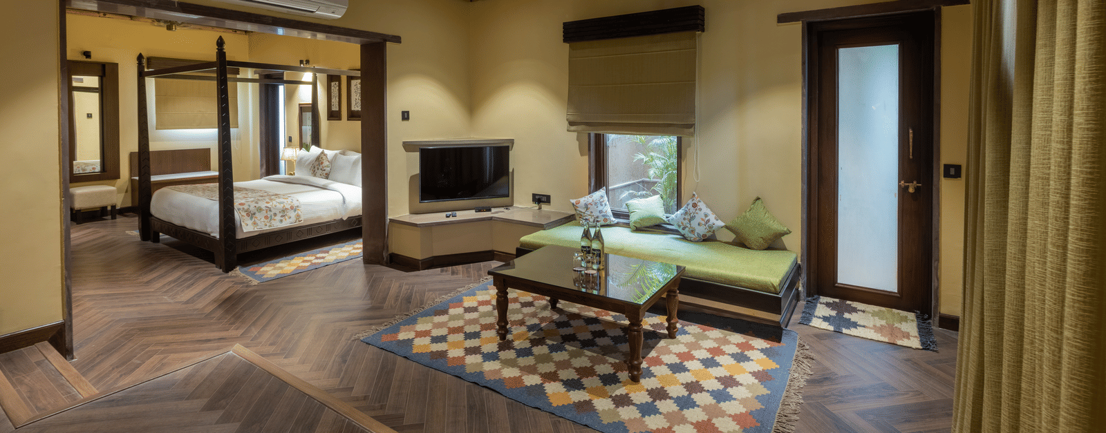 A spacious suite at Aamaghati Wildlife Resort with modern furnishings, soft lighting, and refined décor offering comfort and elegance for guests.