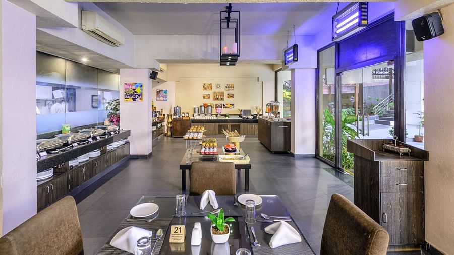 Golden Tulip, Candolim, Goa's restaurant interior, showcasing tables, casual seating, and open space.