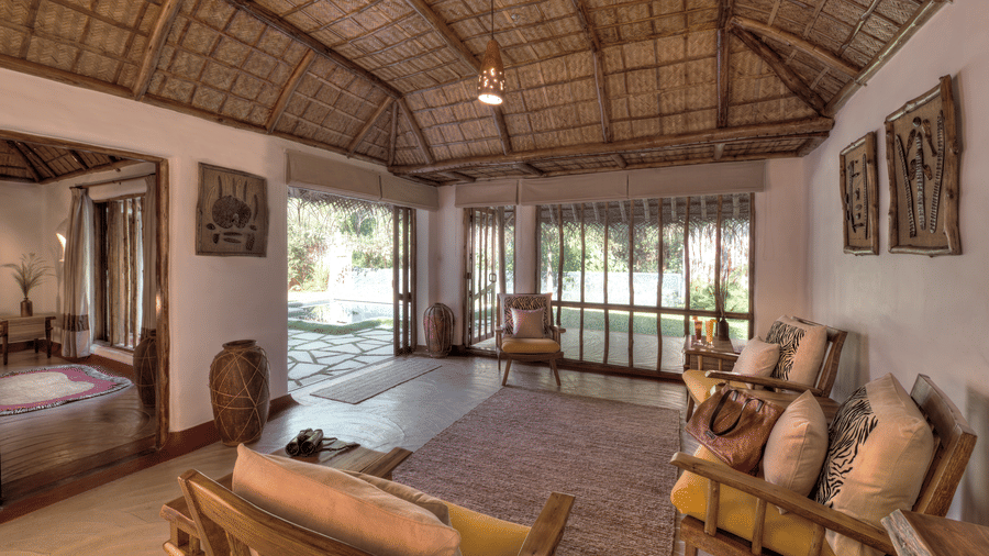 Thatched suite with wooden flooring and garden access at Evolve Back Kabini