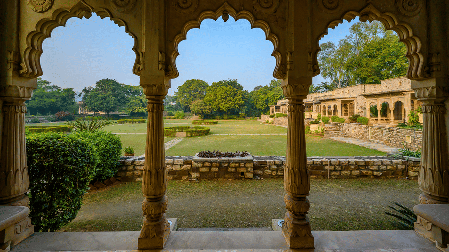 A view of the garden from an ornate arch-shaped hallway in Deo Bagh - 17th Century, Gwalior.