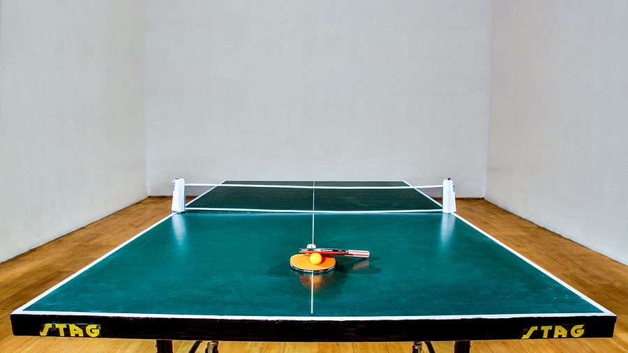 A table with tennis racket and ball placed on it at Tara, Comfort Hotel in Hyderabad - Ramoji Film City.