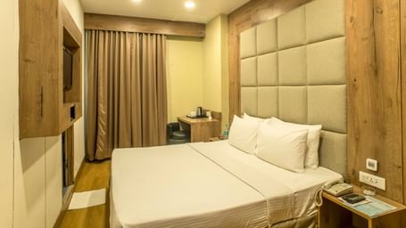 Cosy hotel room with a double bed and a textured headboard | The Citi Residenci Hotel Durgapur