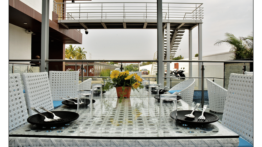 closer view of dining table with plates and cutlery kept atop - Royal Lotus View Resotel1