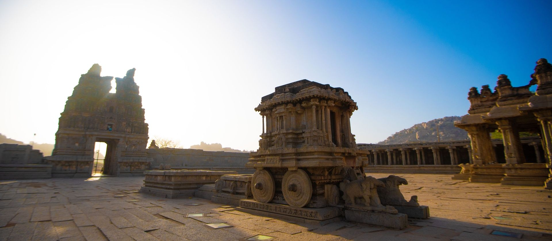 Stone Chariot at Vittala Temple under bright sun.