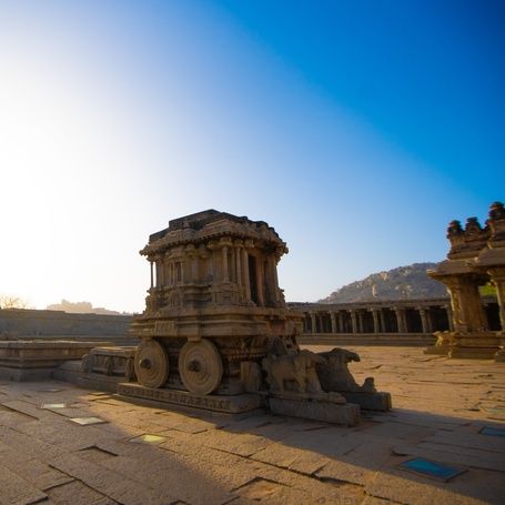 Stone Chariot at Vittala Temple under bright sun.