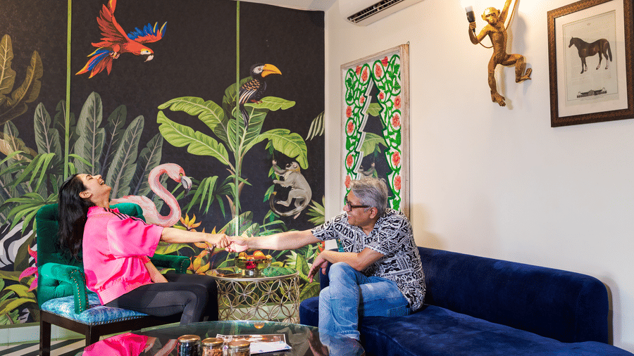 A couple sitting in the living room inside Garden Suite - Karma Lakelands.