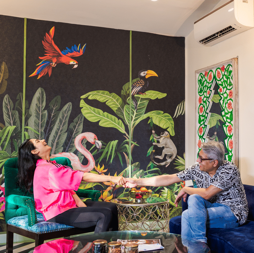 A couple sitting in the living room inside Garden Suite - Karma Lakelands.