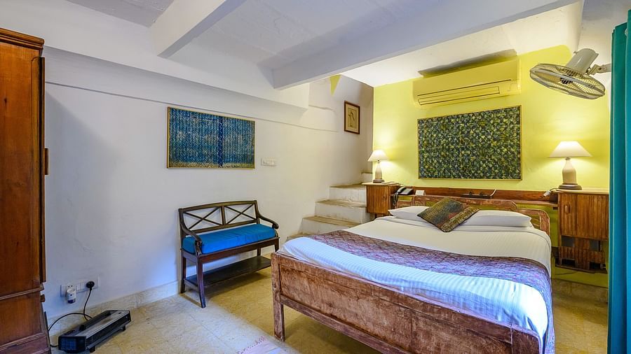 Hill Fort Kesroli 14th Century Alwar - interior view of the Naqqar Khana Mahal - Village View featuring a king size bed with wall mounted fan 