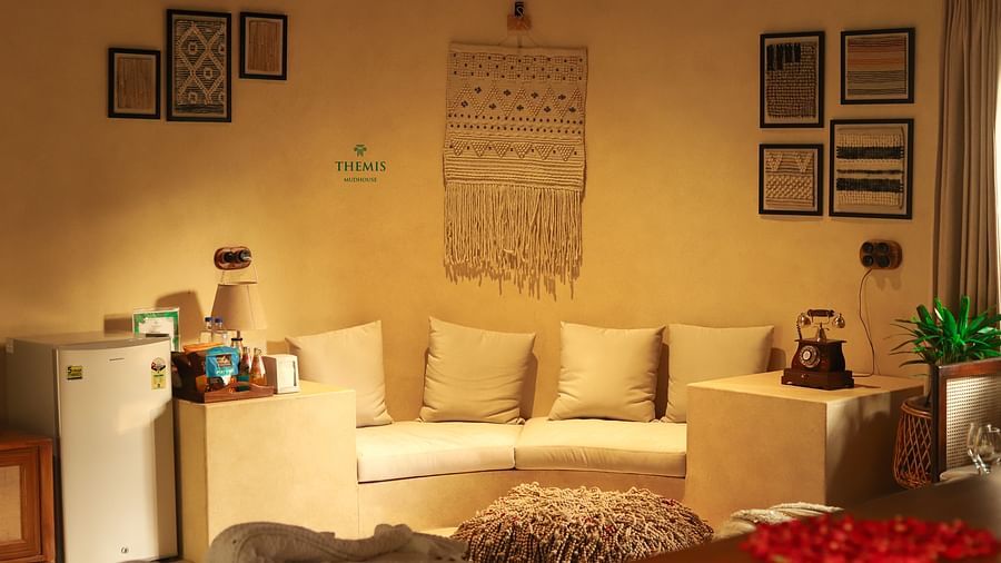 interior of the villa focusing on the sofa with soft cushion at Themis Mudhouse - A Nature's Retreat Resort & Wellness