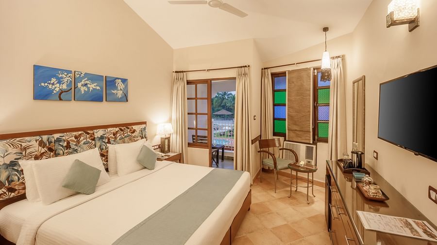 room with a king size bed and modern wooden flooring