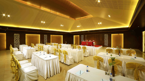 A modern banquet hall with soft lighting, elegant interiors, and well-arranged seating for a comfortable ambience at Uday Samudra Leisure Beach Hotel