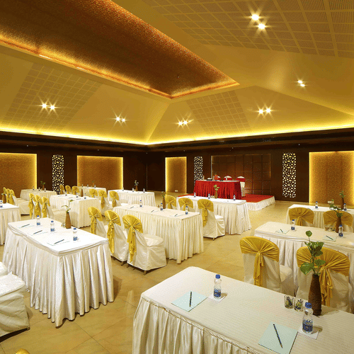 A modern banquet hall with soft lighting, elegant interiors, and well-arranged seating for a comfortable ambience at Uday Samudra Leisure Beach Hotel