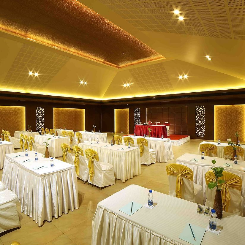 An image of a modern banquet hall with soft lighting, elegant interiors, and well-arranged seating for a comfortable ambience - Uday Samudra Leisure Beach Hotel