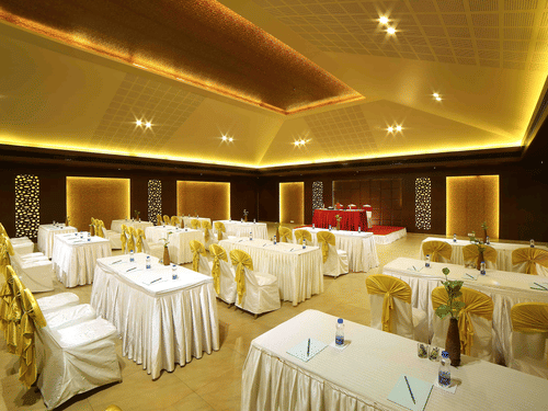 A modern banquet hall with soft lighting, elegant interiors, and well-arranged seating for a comfortable ambience at Uday Samudra Leisure Beach Hotel