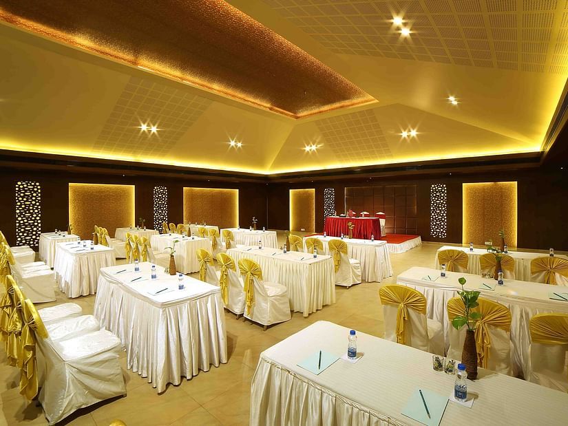 A modern banquet hall with soft lighting, elegant interiors, and well-arranged seating for a comfortable ambience at Uday Samudra Leisure Beach Hotel