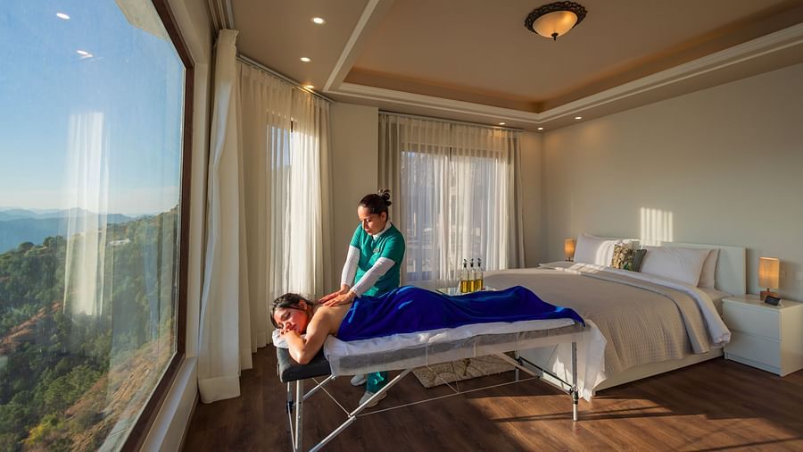 The Manor Shimla - A masseuse massaging a guest in our hotel room
