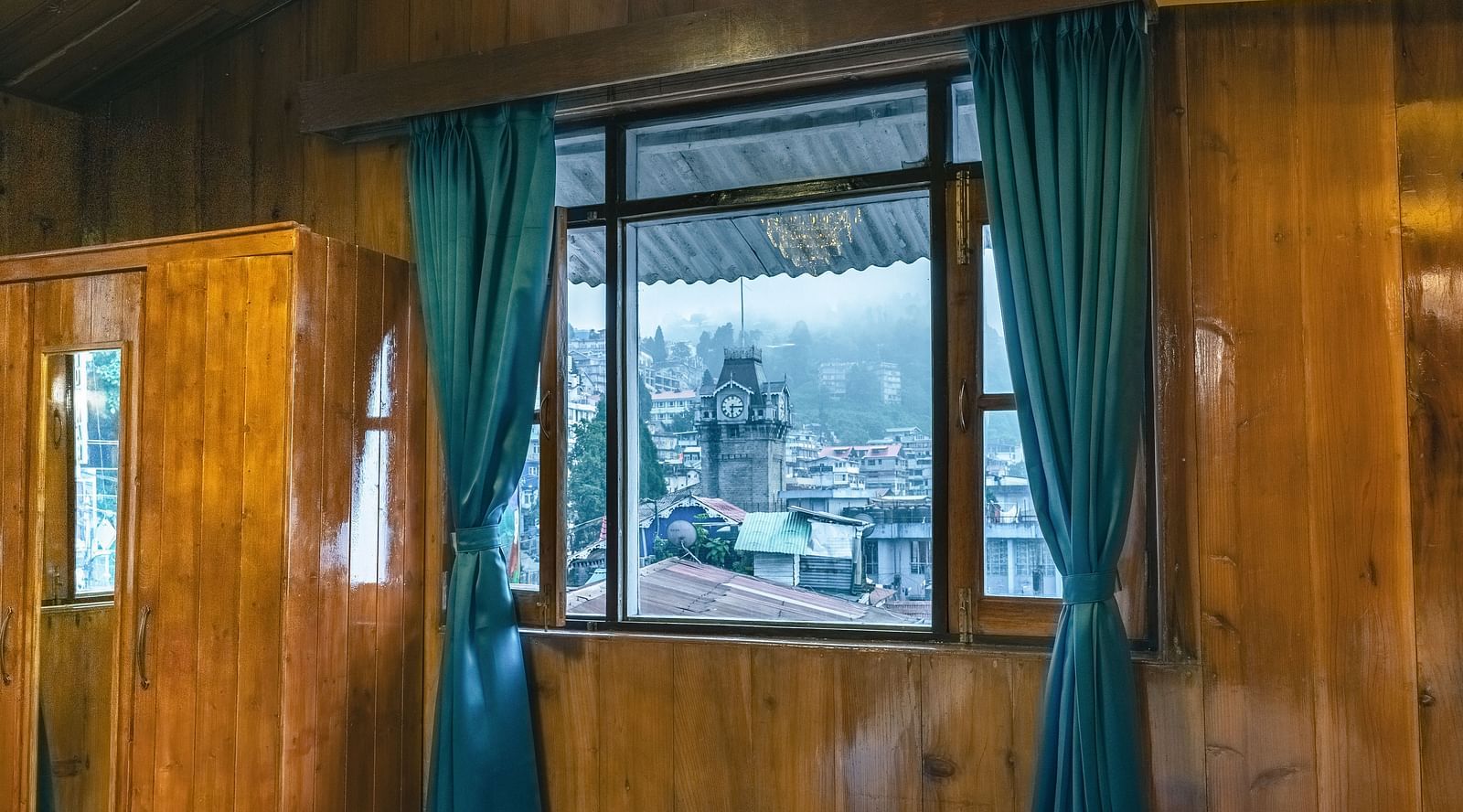 The premium room offers views of the clock tower through its windows, along with warm lighting at Avianna Seven Seas, Darjeeling1